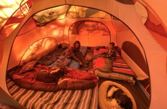 interior or orange tent showing footprint with sleeping bags