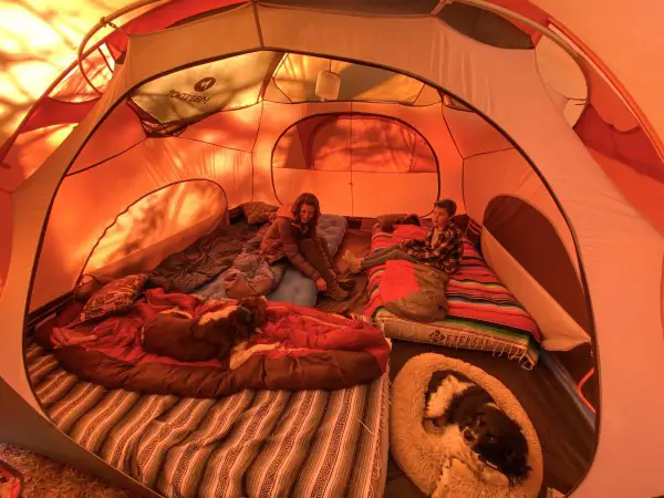 interior or orange tent showing footprint with sleeping bags