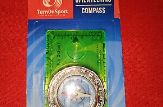 yellow compass in packaging on red background