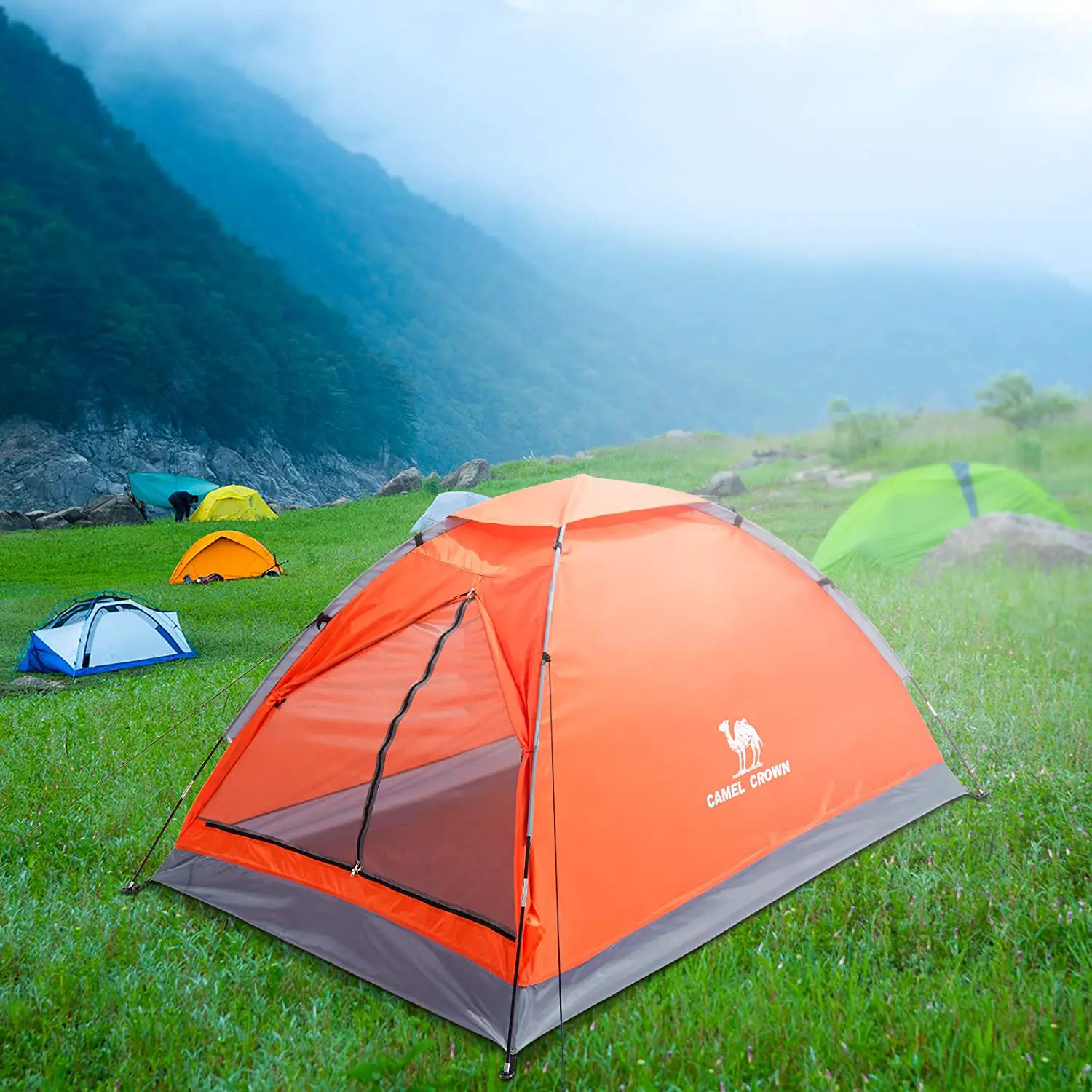 orange tent in foreground of field with other tents
